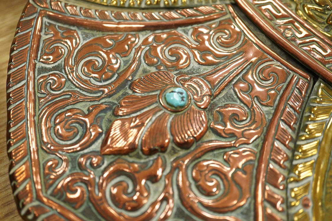 A large Nepalese brass and copper embossed tray, first half 20th century, set with simulated turquoise cabochons, 68cm diameter